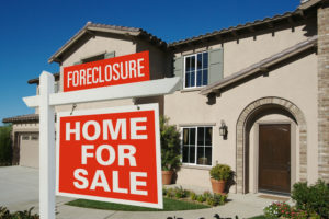 foreclosure sign in front of home 