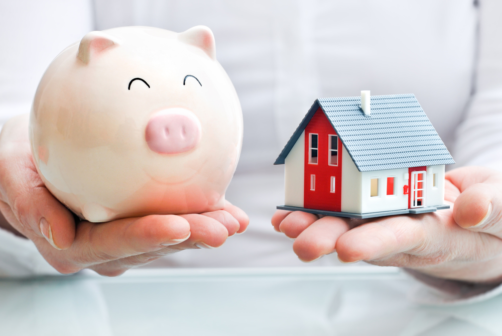 hands holding a house and piggy bank from a garnishment lawyer Yukon OK